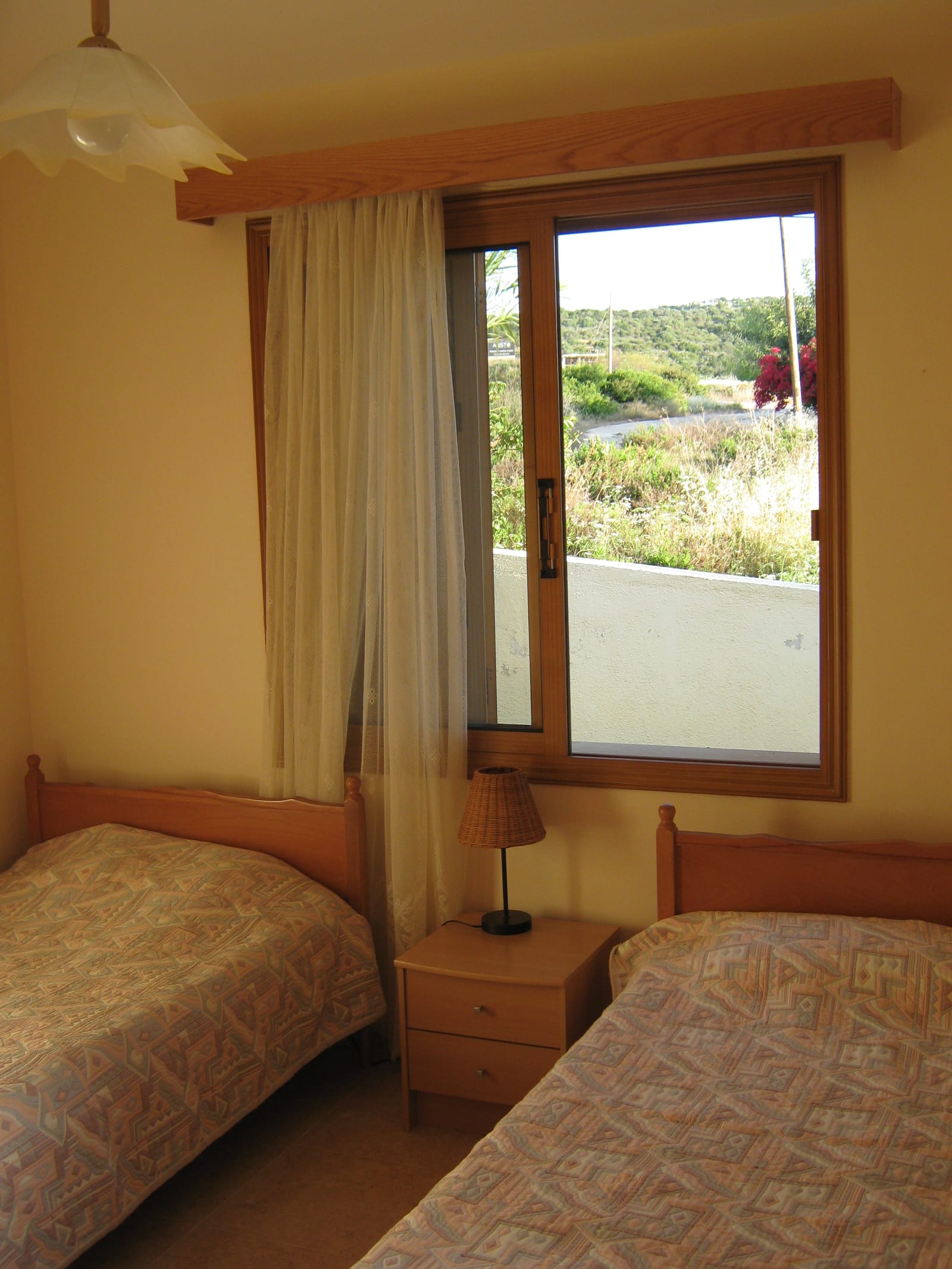 Twin bedroom with two single beds either side of a window