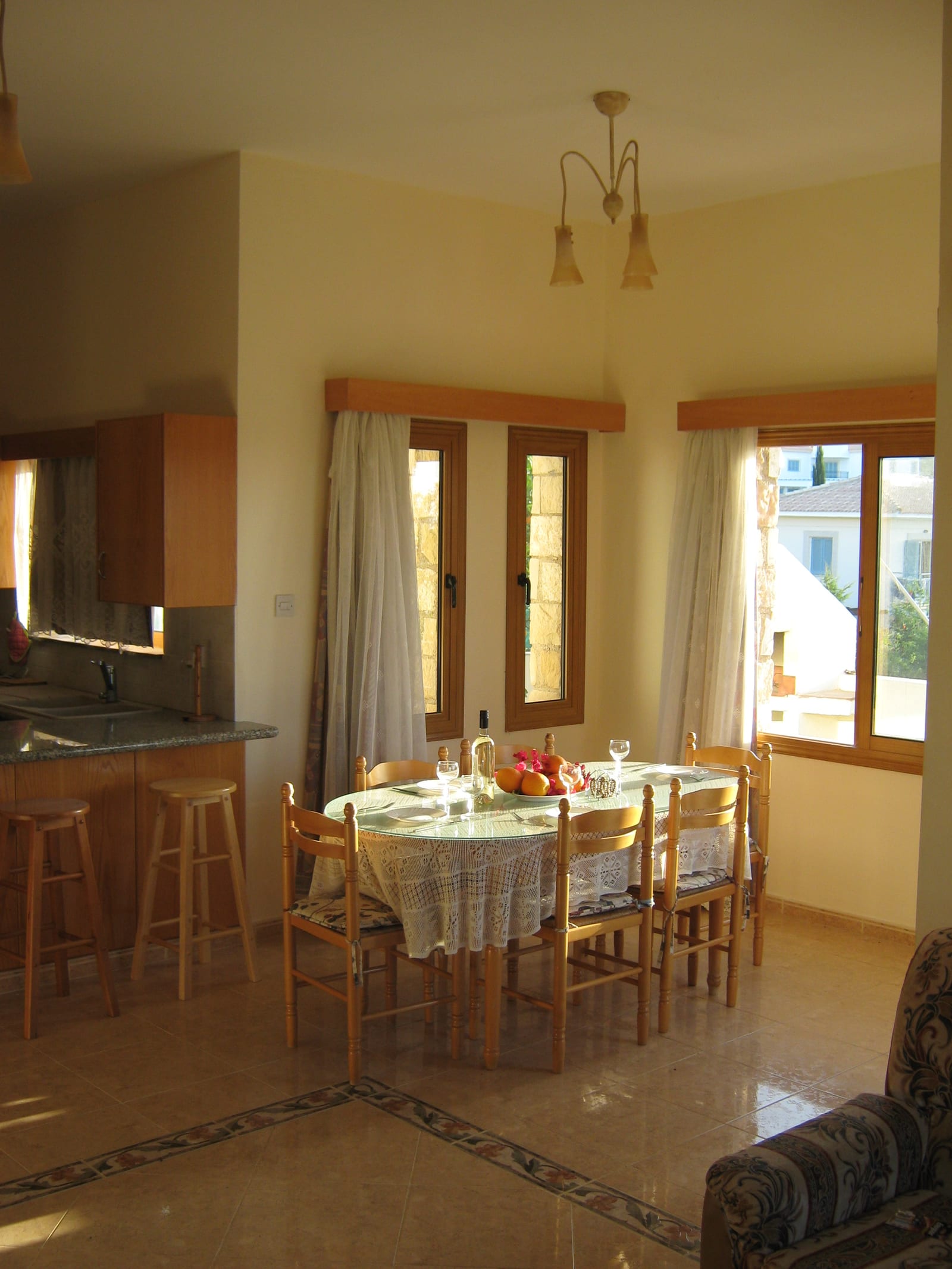 The kitchen and dining area, with tall windows looking out to the garden